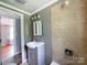 A charming full bathroom offers a modern vanity and shower, plus a mirror and great lighting at 1105 S Church S St, Monroe, NC 28112