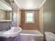 A charming full bathroom offers a modern vanity and shower-tub combination, plus mirror and lighting at 1105 S Church S St, Monroe, NC 28112