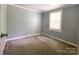Bedroom featuring neutral walls, a window, and carpeted floors, creating a peaceful environment at 1105 S Church S St, Monroe, NC 28112