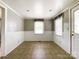 Cozy dining area with tiled floors, wainscoting, and natural light from the window and door at 1105 S Church S St, Monroe, NC 28112