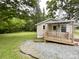 Exterior view of the covered deck and the expansive green lawn surrounding the residence at 1105 S Church S St, Monroe, NC 28112