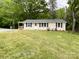 Charming single-story home featuring a well-manicured front yard with green grass and a small porch at 1105 S Church S St, Monroe, NC 28112