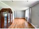 Spacious living room featuring hardwood floors, neutral paint, and a classic display cabinet at 1105 S Church S St, Monroe, NC 28112
