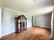 Spacious living room with hardwood floors, recessed lighting, and a classic curio cabinet adding character at 1105 S Church S St, Monroe, NC 28112