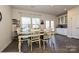 Inviting dining room with a modern table and chairs, adjacent to the kitchen with ample natural light streaming in at 11741 Blessington Rd, Huntersville, NC 28078
