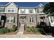 Charming townhome showcasing a stone facade, well-manicured landscaping, and inviting entryway with steps at 11741 Blessington Rd, Huntersville, NC 28078