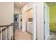 Upstairs hallway features a convenient laundry closet with a washer and dryer, and neutral carpeting at 11741 Blessington Rd, Huntersville, NC 28078