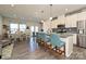 Modern kitchen featuring a spacious island with bar seating, stainless steel appliances, and stylish pendant lighting at 11741 Blessington Rd, Huntersville, NC 28078