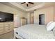 Spacious main bedroom boasts a walk-in closet, dresser, and tray ceiling with ceiling fan at 11741 Blessington Rd, Huntersville, NC 28078
