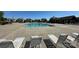 Community swimming pool with lounge chairs, surrounded by lush greenery and residential buildings at 11741 Blessington Rd, Huntersville, NC 28078