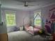 Charming ' room with a whimsical mural, cute bed frame, and sun-drenched windows at 1200 Kent Dr, Lancaster, SC 29720
