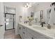 Elegant bathroom featuring a dual-sink vanity with quartz countertop and a separate glass-enclosed shower at 13251 Chopin Ridge Rd, Huntersville, NC 28078