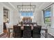 Dining room with a decorative chandelier, a large dining table, and neutral decor at 13251 Chopin Ridge Rd, Huntersville, NC 28078