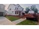 Unfinished two-story home with an attached two-car garage and a sidewalk at 13251 Chopin Ridge Rd, Huntersville, NC 28078