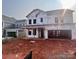 Unfinished two-story home featuring an attached two-car garage and a covered porch at 13251 Chopin Ridge Rd, Huntersville, NC 28078