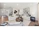 Open-concept living room with stylish sofas, modern artwork, and decorative accents at 13251 Chopin Ridge Rd, Huntersville, NC 28078