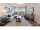 Comfortable living room featuring a plush sectional sofa, media center, and large windows at 13251 Chopin Ridge Rd, Huntersville, NC 28078