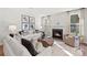Cozy living room featuring a fireplace, plush sofas, decorative pillows, and a unique coffee table at 13251 Chopin Ridge Rd, Huntersville, NC 28078