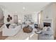 Inviting living room featuring a fireplace, stylish sofas, and contemporary decor at 13251 Chopin Ridge Rd, Huntersville, NC 28078