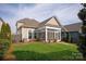 Manicured backyard featuring a screened porch and lush green lawn at 13818 Jacks Ln, Pineville, NC 28134