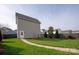 A walkway leads across the green backyard to a detached garage at 13818 Jacks Ln, Pineville, NC 28134