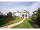 Beautifully landscaped backyard with a screened porch and lush lawn at 13818 Jacks Ln, Pineville, NC 28134