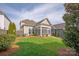 Manicured backyard featuring a screened porch and lush green lawn at 13818 Jacks Ln, Pineville, NC 28134