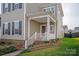 Beautiful home with a welcoming front porch, lush landscaping, and classic design elements at 13818 Jacks Ln, Pineville, NC 28134