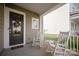 Inviting front porch with rocking chairs, perfect for relaxing and enjoying the neighborhood views at 13818 Jacks Ln, Pineville, NC 28134