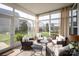 Bright sunroom with comfortable seating, perfect for enjoying the outdoors year-round at 13818 Jacks Ln, Pineville, NC 28134