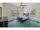 Cozy bedroom with natural light from two windows and dark furniture at 140 Ribbon Cir, Lincolnton, NC 28092