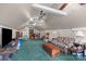 Large bonus room with seating, storage, ceiling fans, and natural light at 140 Ribbon Cir, Lincolnton, NC 28092