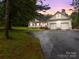 Charming home with an attached two-car garage and spacious front yard at dusk at 140 Ribbon Cir, Lincolnton, NC 28092