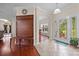 Welcoming foyer featuring a coat rack, tile floor, and glass-paneled front door at 140 Ribbon Cir, Lincolnton, NC 28092