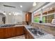 Kitchen featuring stainless steel sink, wood cabinets, granite countertops, and tile flooring at 140 Ribbon Cir, Lincolnton, NC 28092