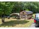 Rustic outbuilding with a covered carport area offering ample storage and utility space on the property at 140 Ribbon Cir, Lincolnton, NC 28092
