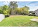 Expansive backyard featuring lush green lawn and privacy with bamboo trees and black wrought iron fence at 16019 Kelby Cv, Charlotte, NC 28278