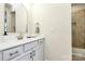 Elegant bathroom featuring a modern vanity with sink, granite countertops, and tiled shower at 16019 Kelby Cv, Charlotte, NC 28278