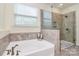 Relaxing bathroom showcasing a luxurious soaking tub and a separate walk-in shower at 16019 Kelby Cv, Charlotte, NC 28278