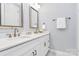 Bright bathroom featuring double vanity with white countertops, framed mirrors, and soft blue walls at 16019 Kelby Cv, Charlotte, NC 28278