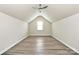 Spacious bonus room boasts vaulted ceilings, a window, recessed lighting and wood-look floors at 16019 Kelby Cv, Charlotte, NC 28278