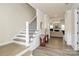 Elegant entryway featuring hardwood floors, staircase, and views to the living room at 16019 Kelby Cv, Charlotte, NC 28278