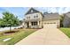 Inviting two-story home featuring a well-manicured lawn and a spacious driveway at 16019 Kelby Cv, Charlotte, NC 28278