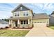 Charming two-story home with a welcoming front porch and well-maintained lawn at 16019 Kelby Cv, Charlotte, NC 28278