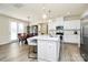 Bright kitchen with stainless steel appliances, an island with seating, and hardwood floors at 16019 Kelby Cv, Charlotte, NC 28278