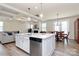 Open-concept kitchen with an island, stainless steel appliances, and hardwood floors at 16019 Kelby Cv, Charlotte, NC 28278