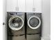 Laundry room featuring side-by-side Electrolux washer and dryer and cabinets. The room has overhead lighting at 16019 Kelby Cv, Charlotte, NC 28278