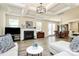 Spacious living room with a fireplace, hardwood floors, and an adjacent dining area at 16019 Kelby Cv, Charlotte, NC 28278
