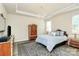 Well-decorated main bedroom featuring tray ceilings, hardwood floors, and plenty of natural light at 16019 Kelby Cv, Charlotte, NC 28278