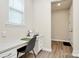 Bright home office area with built-in desk, drawers, and natural light from the window at 16019 Kelby Cv, Charlotte, NC 28278